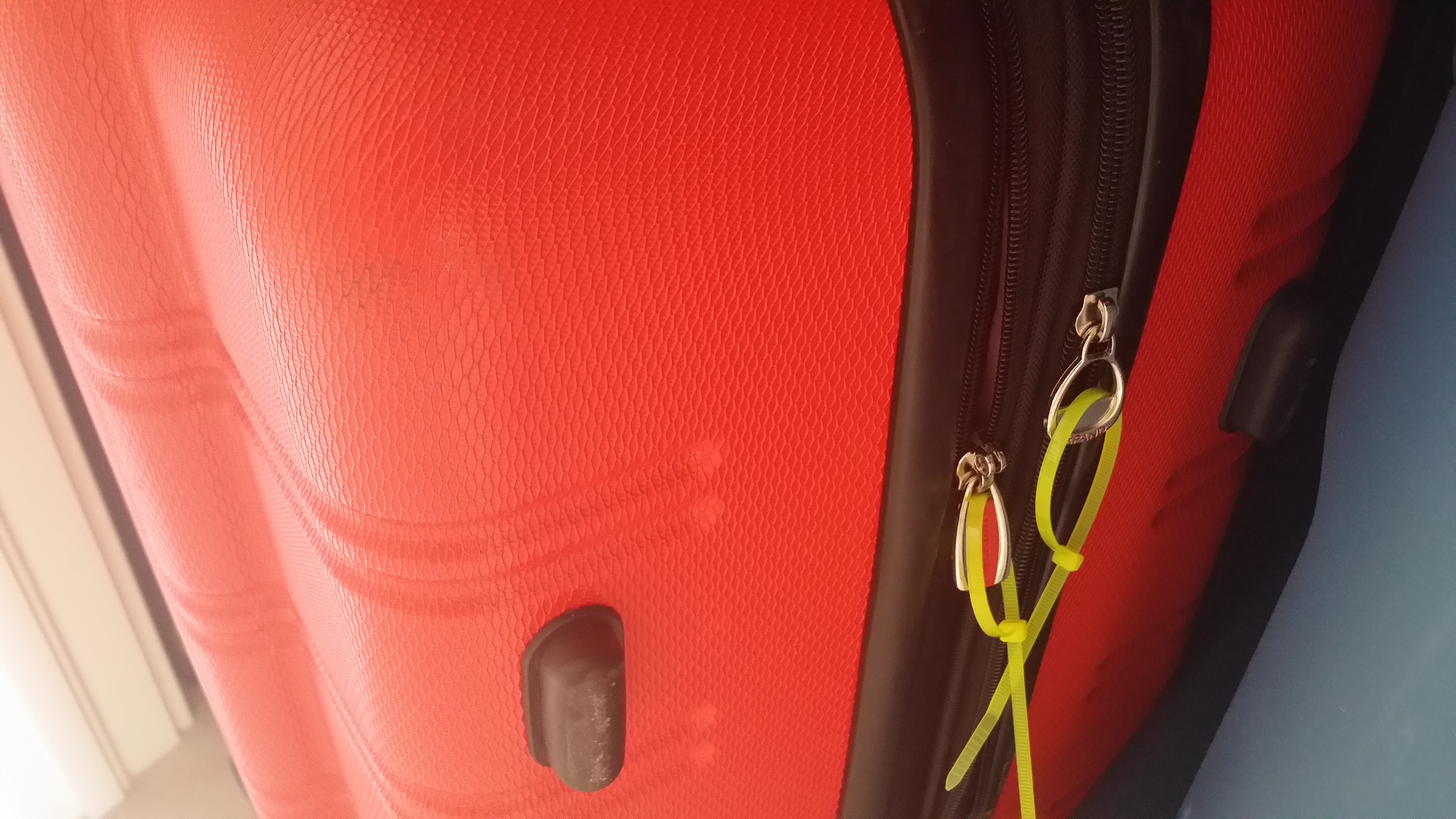 know your luggage from across the room by attaching a few 8" neon yellow cable ties